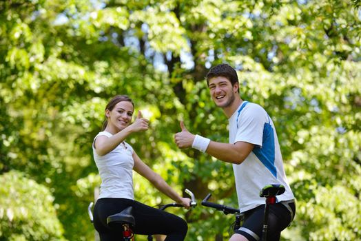 Happy couple ride bicycle outdoors, health lifestyle fun love romance concept