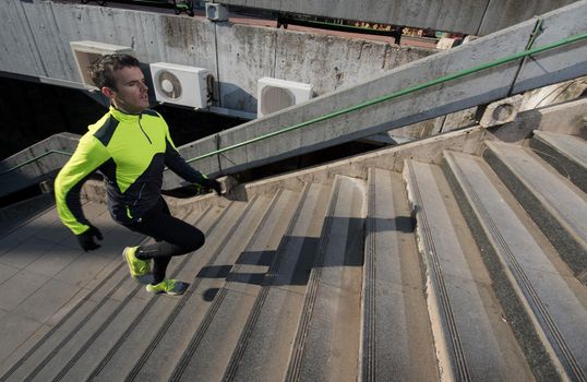 man jogging  at cold autumn  mornigng on steps