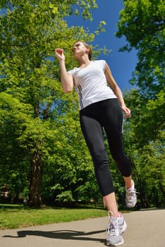 Young beautiful  woman jogging on morning at  park. Woman in sport outdoors health concept