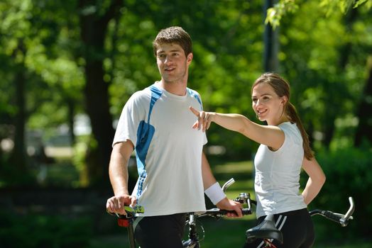 Happy couple ride bicycle outdoors, health lifestyle fun love romance concept