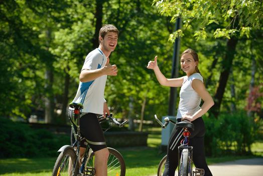 Happy couple ride bicycle outdoors, health lifestyle fun love romance concept