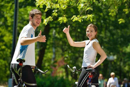 Happy couple ride bicycle outdoors, health lifestyle fun love romance concept