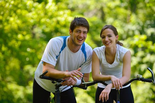 Happy couple ride bicycle outdoors, health lifestyle fun love romance concept