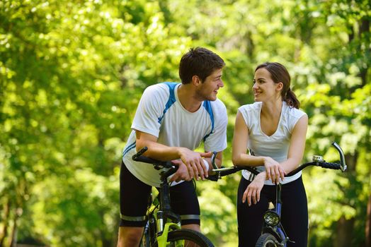 Happy couple ride bicycle outdoors, health lifestyle fun love romance concept