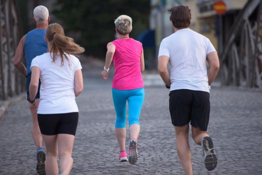 people group jogging  runners team on morning  training workout with sunrise in background