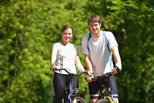 Happy couple ride bicycle outdoors, health lifestyle fun love romance concept