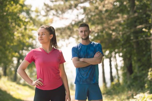 a portrait of a young couple preparing for a morning run and morning exercise