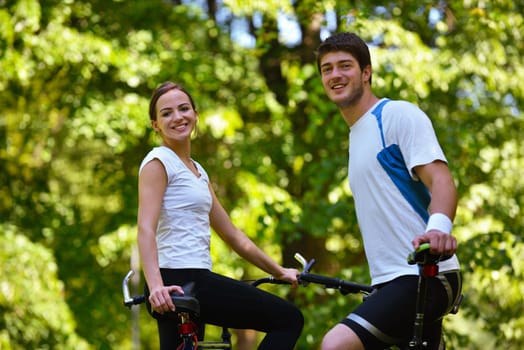 Happy couple ride bicycle outdoors, health lifestyle fun love romance concept