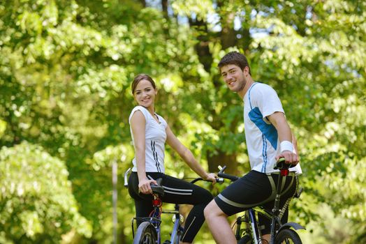 Happy couple ride bicycle outdoors, health lifestyle fun love romance concept