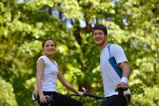 Happy couple ride bicycle outdoors, health lifestyle fun love romance concept