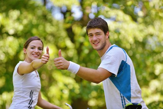 Happy couple ride bicycle outdoors, health lifestyle fun love romance concept