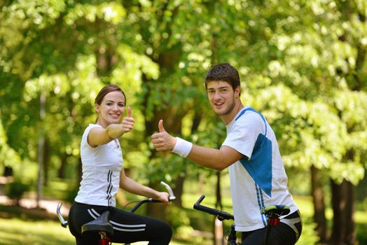 Happy couple ride bicycle outdoors, health lifestyle fun love romance concept