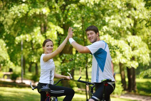 Happy couple ride bicycle outdoors, health lifestyle fun love romance concept