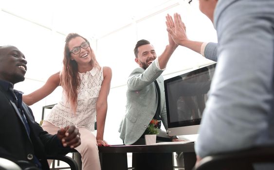 employees greet each other in the office.the concept of teamwork