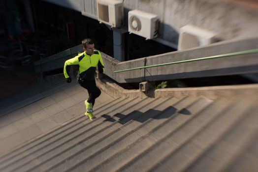 man jogging  at cold autumn  mornigng on steps