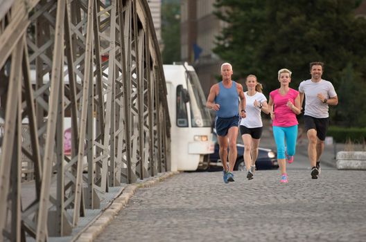 people group jogging  runners team on morning  training workout with sunrise in background