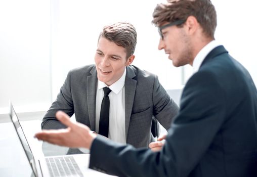 two businessmen use a laptop in the office.people and technology