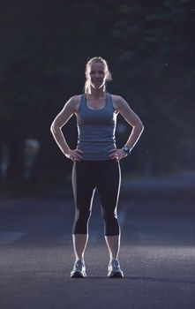 runner   woman warming up and stretching before morning jogging