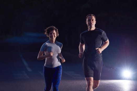 urban sports, healthy couple jogging in the city at early morning in night