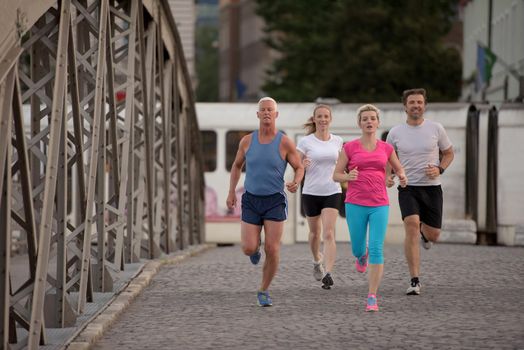 people group jogging  runners team on morning  training workout with sunrise in background