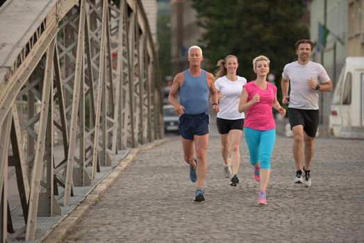 people group jogging  runners team on morning  training workout with sunrise in background