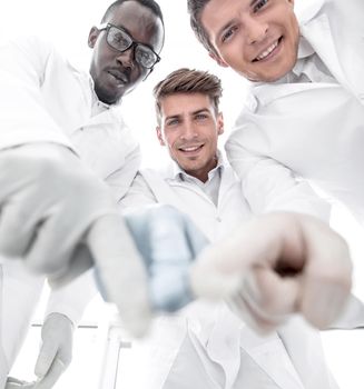 group of scientists pointing to the laboratory table.concept of success