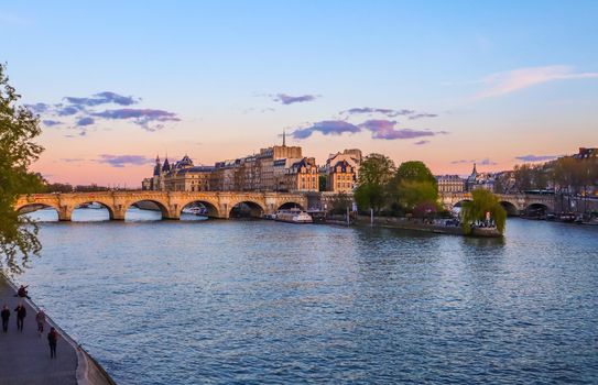 The oldest bridge ( Pont Neuf ) across Seine River and historic buildings of Paris France at sunset. April 2019