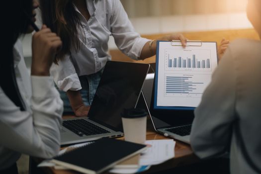 Analytics intelligence concept. Group of business people discuss current financial and economic on laptop for investment at the meeting