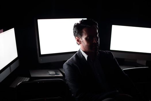 tired businessman working in the computer room late.people and technology