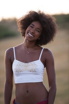 Healthy Looking Smiling Young African American Female beautiful summer evening in nature