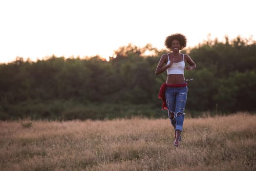 Healthy Looking Smiling Young African American Female beautiful summer evening in nature