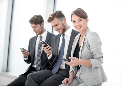 smiling employees using their smartphones.people and technology