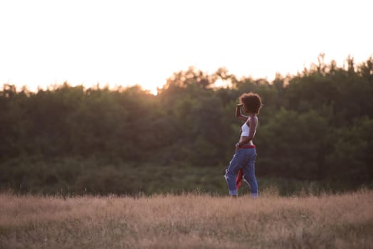 Healthy Looking Smiling Young African American Female beautiful summer evening in nature