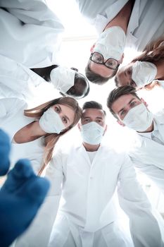 Surgeons in operating theatre looking down at patient, personal perspective