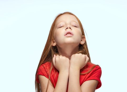 girl with red hair posing red t-shirt childhood. High quality photo
