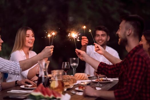 group of happy friends having picnic french dinner party outdoor during summer holiday vacation near the river at beautiful nature