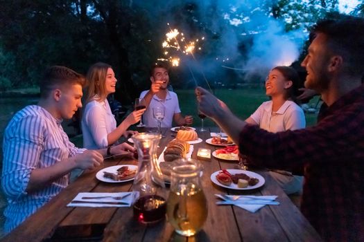 group of happy friends having picnic french dinner party outdoor during summer holiday vacation near the river at beautiful nature