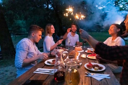 group of happy friends having picnic french dinner party outdoor during summer holiday vacation near the river at beautiful nature