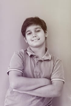 Portrait of a happy young boy in front of colored background