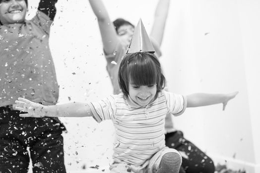 Happy kids celebrating party with blowing confetti