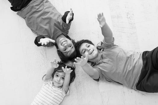 happy young boys having fun on the floor in a new modern home