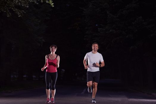 urban sports, healthy couple jogging in the city at early morning in night