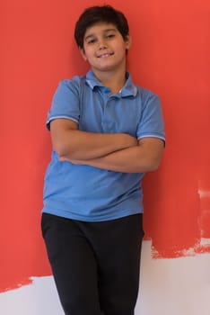 Portrait of a happy young boy in front of colored background