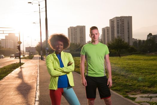 portrait of a young African American beautiful woman and a young man jogging in the city