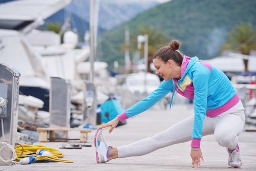 woman jogging at early morning with yacht boats in marina