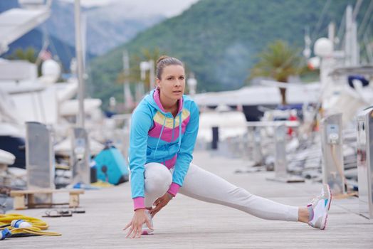 woman jogging at early morning with yacht boats in marina