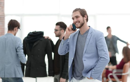 designer talking on a cell phone in his Studio .photo with copy space