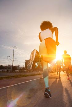 young black girl on the jogging beautiful morning as the sun rises in the streets of the city