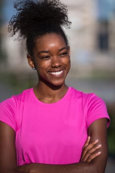 portrait of a young African American girl to run beautiful summer morning on city streets