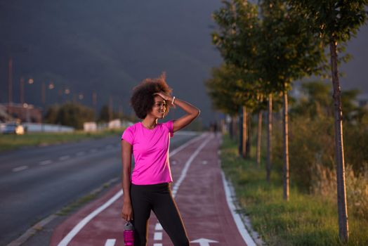 portrait of a young African American girl to run beautiful summer evening on city streets